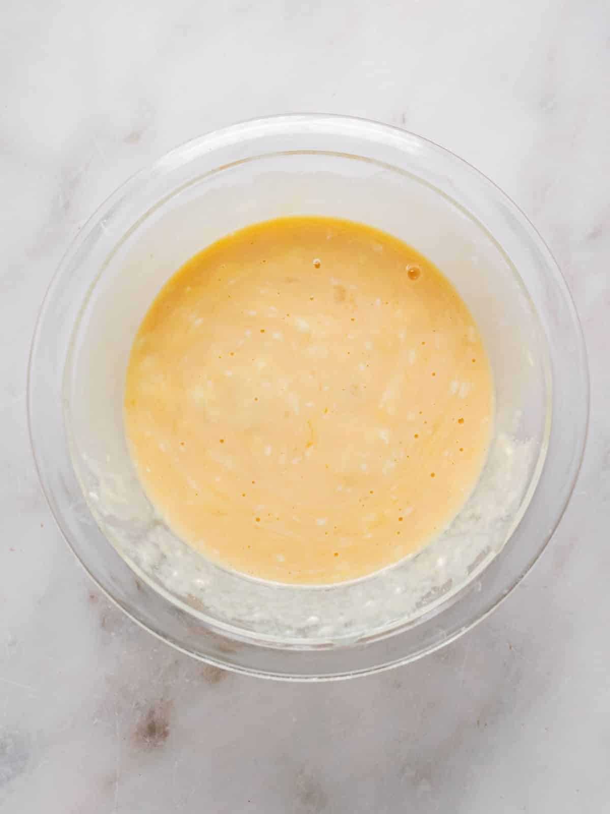 Oil, maple syrup, eggs, Greek yogurt, vanilla extract, and lemon in another mixing bowl.