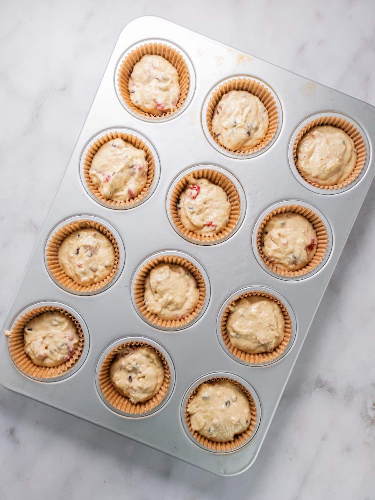 The muffin batter poured into the muffin tins.