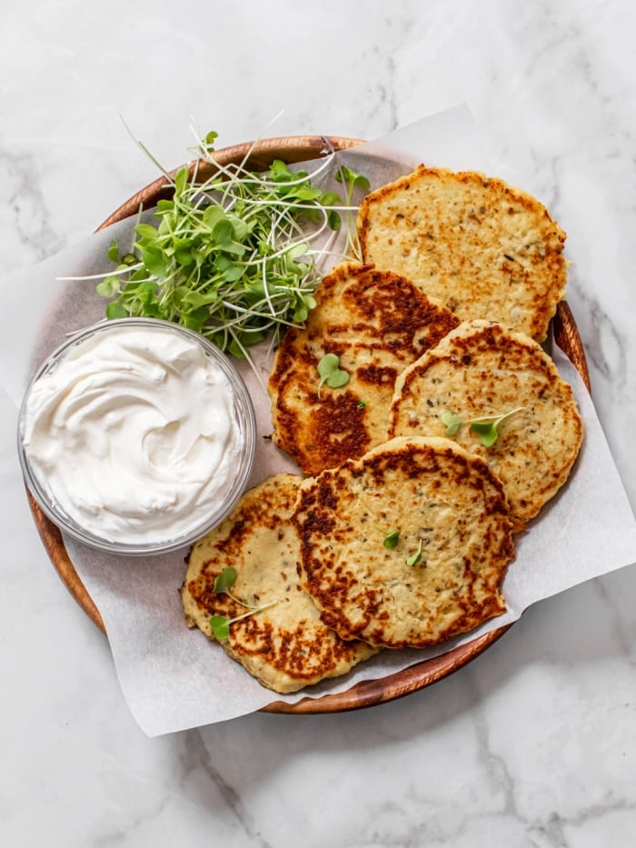 Healthy Cauliflower Pancakes taste like potato pancakes without the carbs. A savory pancakes that's versatile. You can eat them for breakfast, lunch or a snack!
