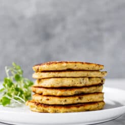 Healthy Cauliflower Pancakes taste like potato pancakes without the carbs. A savory pancakes that's versatile. You can eat them for breakfast, lunch or a snack!
