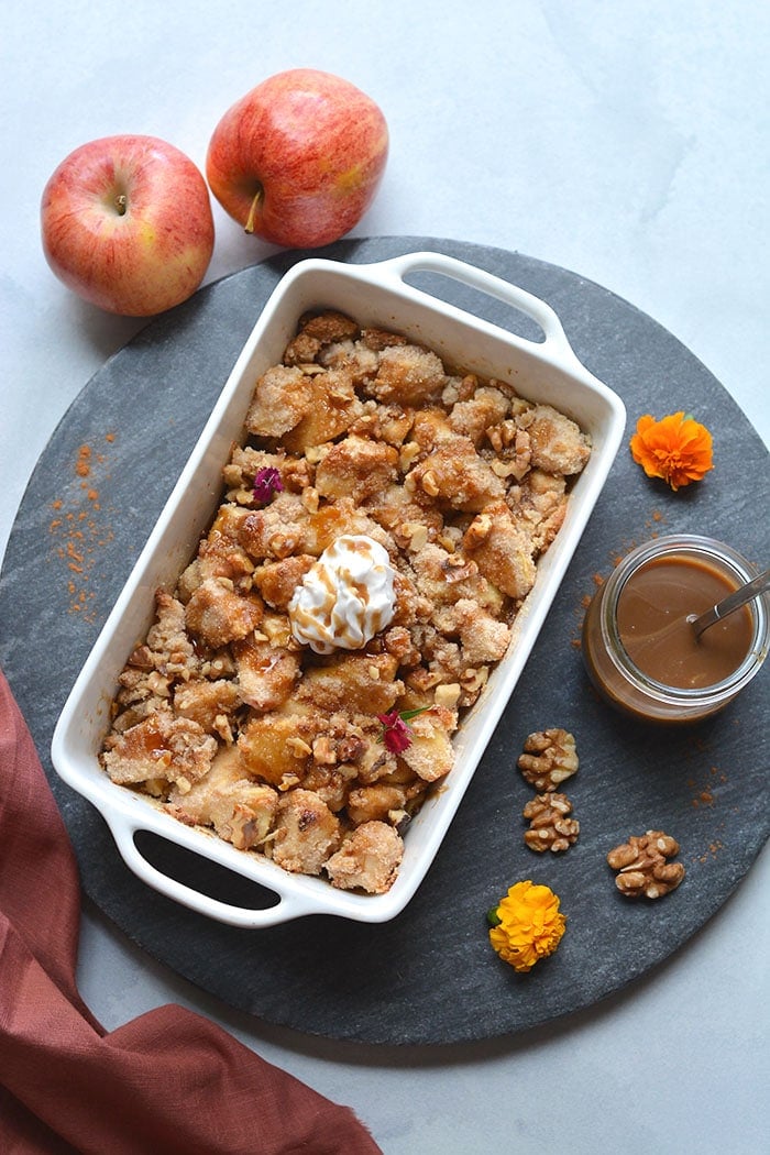 Gluten Free Apple Crisp made with almond flour, cinnamon and lower in sugar. An easy apple crisp that's better balanced in nutrition and dairy free. A healthy dessert recipe that everyone goes crazy for! Gluten Free + Low Calorie + Paleo