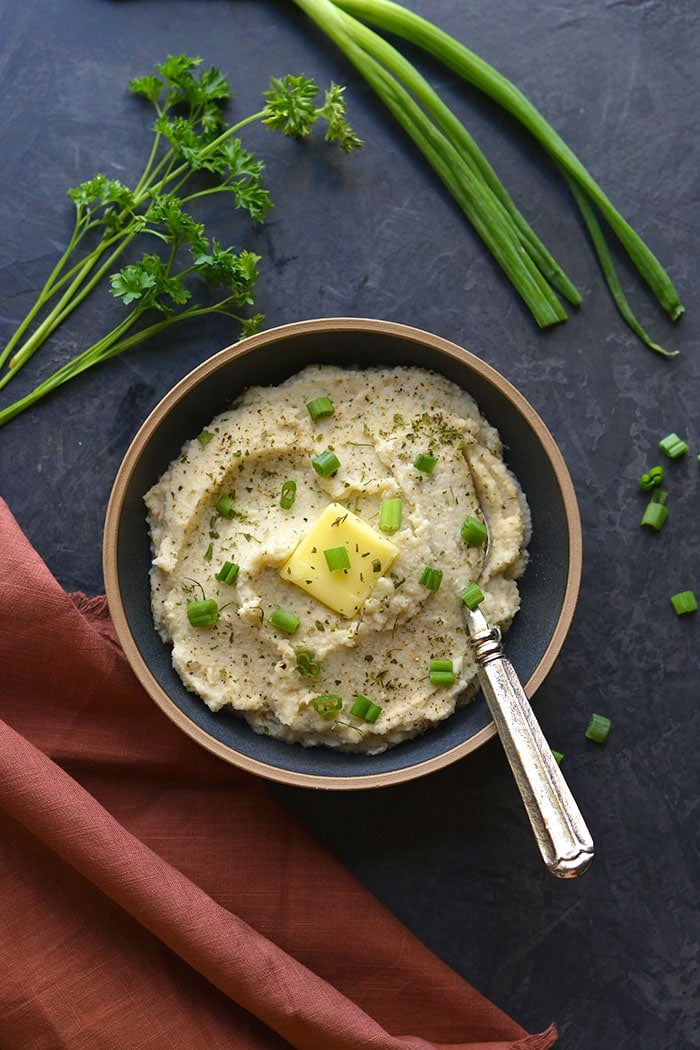 Whole30 Roasted Garlic Cauliflower Mash! These creamy "potatoes" are a healthy low carb alternative to mashed potatoes. Made with simple, real food ingredients with the same consistency as real potatoes. 