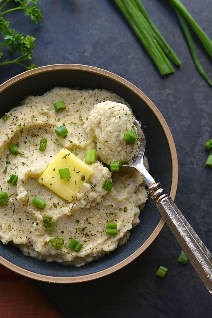 Whole30 Roasted Garlic Cauliflower Mash! These creamy "potatoes" are a healthy low carb alternative to mashed potatoes. Made with simple, real food ingredients with the same consistency as real potatoes. 