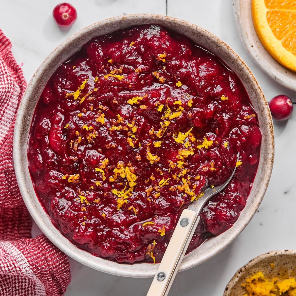 Homemade Sugar Free Cranberry Sauce naturally sweetened with oranges and spices. Easy, warm, filling! Wonderful as a side or gift. Gluten Free + Paleo + Vegan + Low Calorie