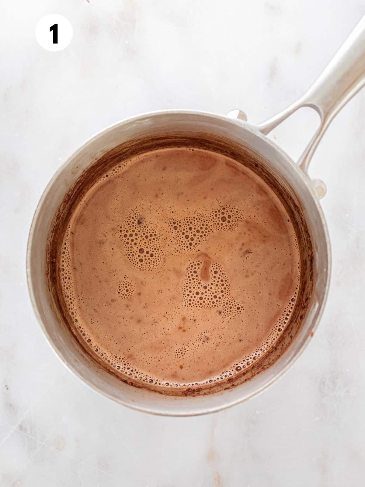 Ingredients for making peanut butter hot chocolate in a pan.