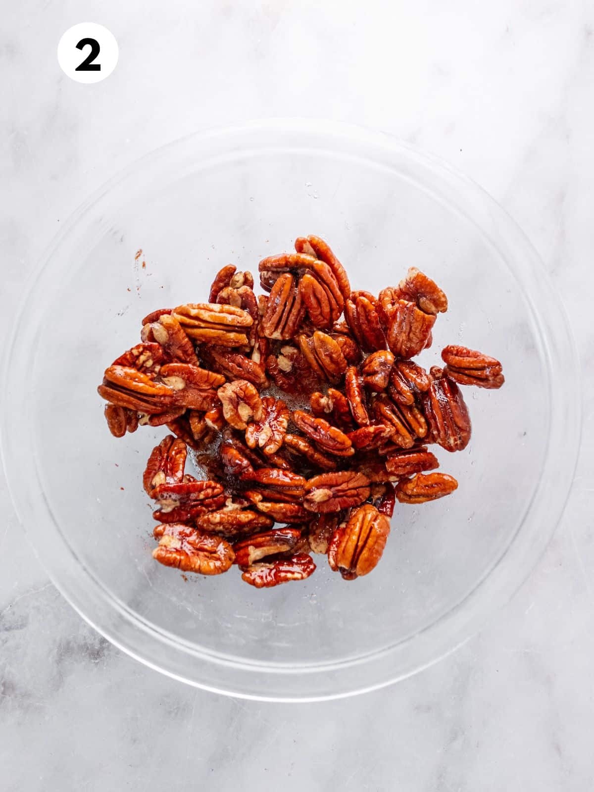 Prepared pecans in a glass bowl.
