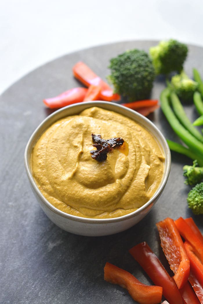 Sun Dried Tomato Red Pepper Hummus made bean free with zucchini, sun dried tomato, garlic and red peppers yum! Thick, creamy and with a spicy kick, this healthy hummus makes a delicious veggie dipper or marinade. Gluten Free + Low Carb + Low Calorie + Paleo + Vegan