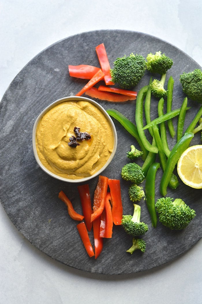 Sun Dried Tomato Red Pepper Hummus made bean free with zucchini, sun dried tomato, garlic and red peppers yum! Thick, creamy and with a spicy kick, this healthy hummus makes a delicious veggie dipper or marinade. Gluten Free + Low Carb + Low Calorie + Paleo + Vegan