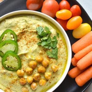 Spicy Cilantro Jalapeño Hummus! Made with fresh ingredients and a kick of spice. This homemade hummus is sure to brighten your plate! Perfect for dipping or using as a marinade. Gluten Free + Vegan + Gluten Free