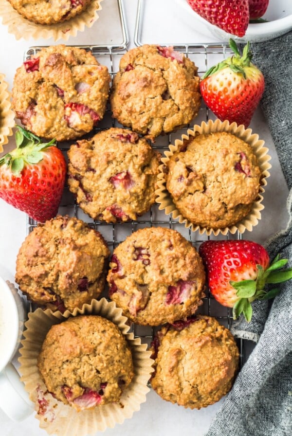 Strawberry Greek Yogurt Muffins! Bursting with strawberries and creamy greek yogurt, these easy to make muffins make a delicious low calorie breakfast or snack for just 84 calories. Quick to make and gluten free too!