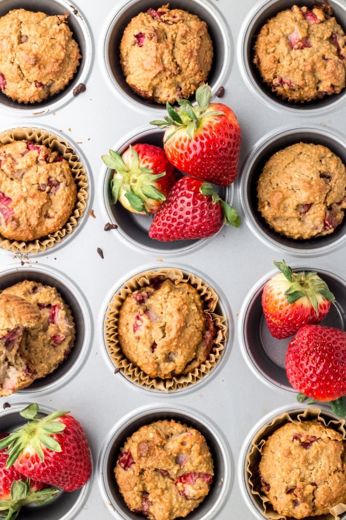 Strawberry Greek Yogurt Muffins! Bursting with strawberries and creamy greek yogurt, these easy to make muffins make a delicious low calorie breakfast or snack for just 84 calories. Quick to make and gluten free too! 
