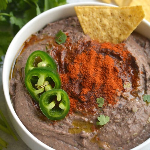Spicy Black Bean Hummus Without Tahini lightened up by omitting the traditional ingredient without sacrificing taste. Pair with veggies & crackers for a healthy snack or spread on sandwich for extra protein & spice! Gluten Free + Vegan + Low Calorie