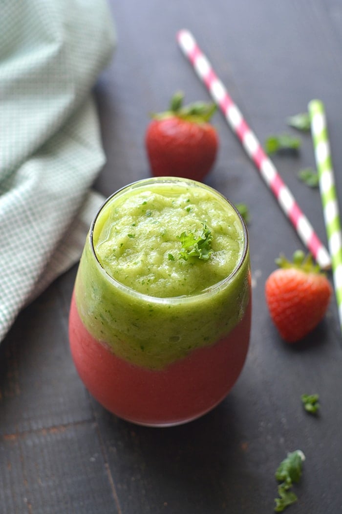 Vegan Kale Strawberry Pineapple Smoothie! A layered smoothie made banana free, dairy free and naturally sweetened with stevia and applesauce. Almost too pretty to eat! Gluten Free + Low Calorie + Vegan