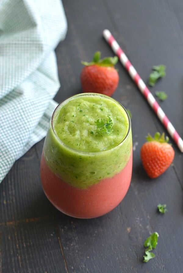 Vegan Kale Strawberry Pineapple Smoothie! A layered smoothie made banana free, dairy free and naturally sweetened with stevia and applesauce. Almost too pretty to eat! Gluten Free + Low Calorie + Vegan