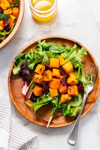 Healthy Butternut Squash Cranberry Salad is a warm fall salad with roasted squash topped with orange cinnamon dressing!