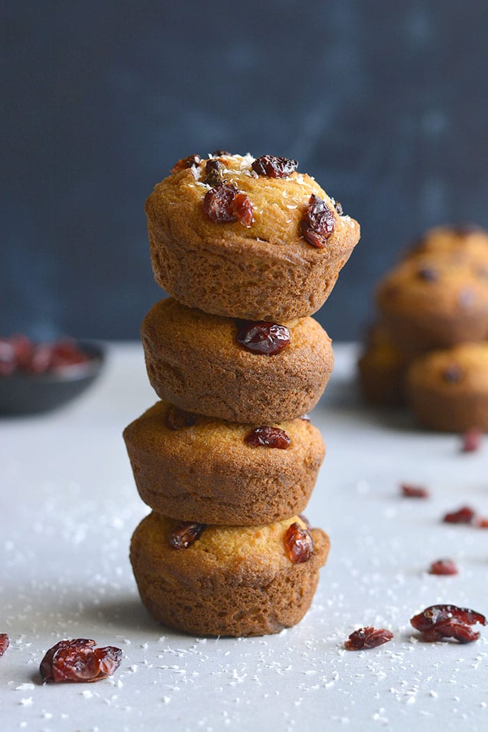 Delicious Coconut Cranberry Muffins made with Greek yogurt, coconut and oat flour are lightly sweetened. A healthier gluten free breakfast or snack on the go. Gluten Free + Low Calorie