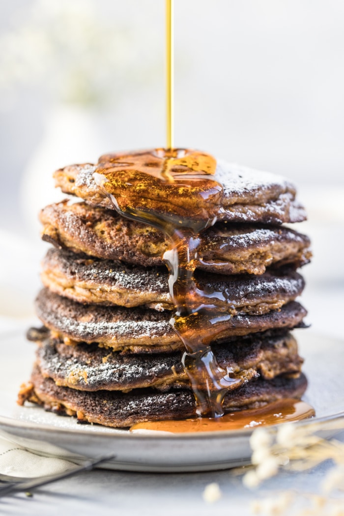 Pumpkin Coconut Pancakes made with coconut flour, nut butter, pumpkin and bananas! These thick, cake-like pancakes are perfect for a hearty fall breakfast. The BEST coconut flour pumpkin pancakes ever!