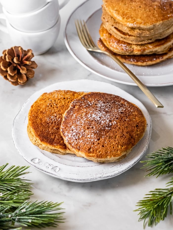 Skinny Gingerbread Pancakes are an easy, low calorie and gluten free breakfast. Made with 10 basic ingredients, these pancakes are great for meal prepping and holiday or winter eating! 