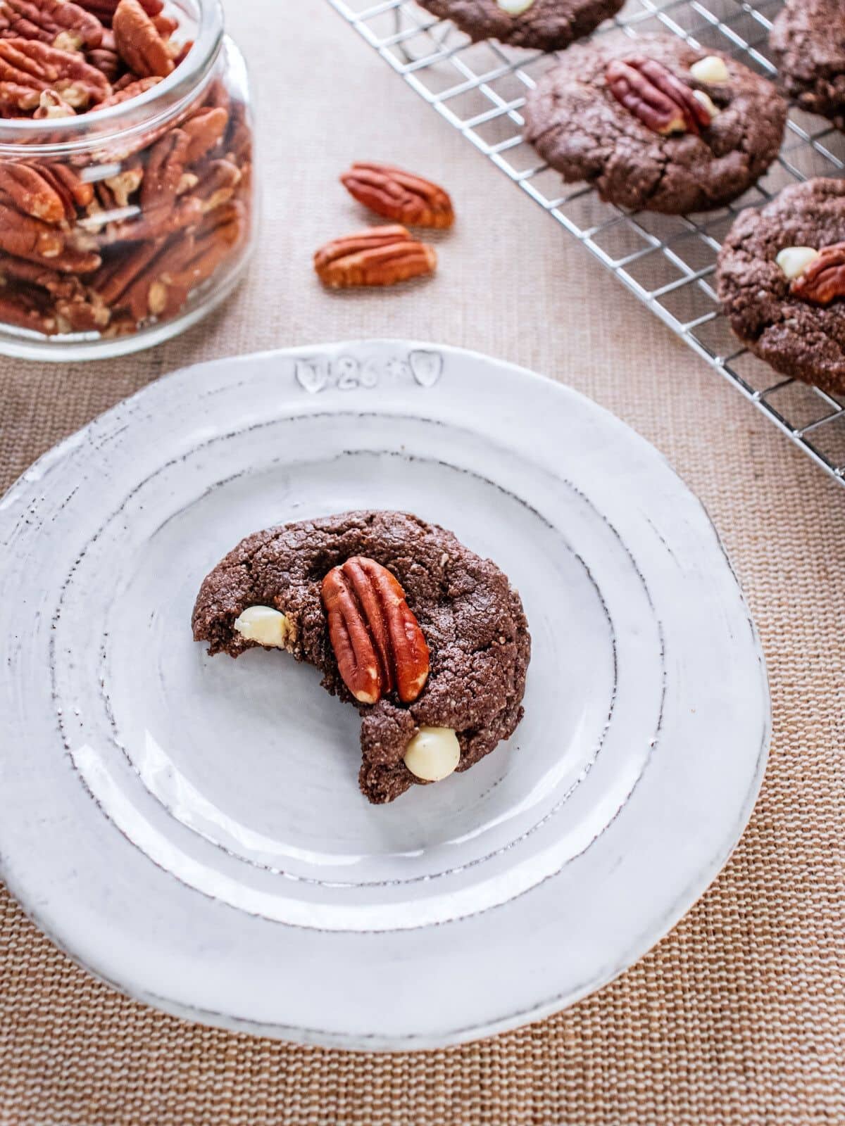 A white chocolate pecan cookie on a plate.