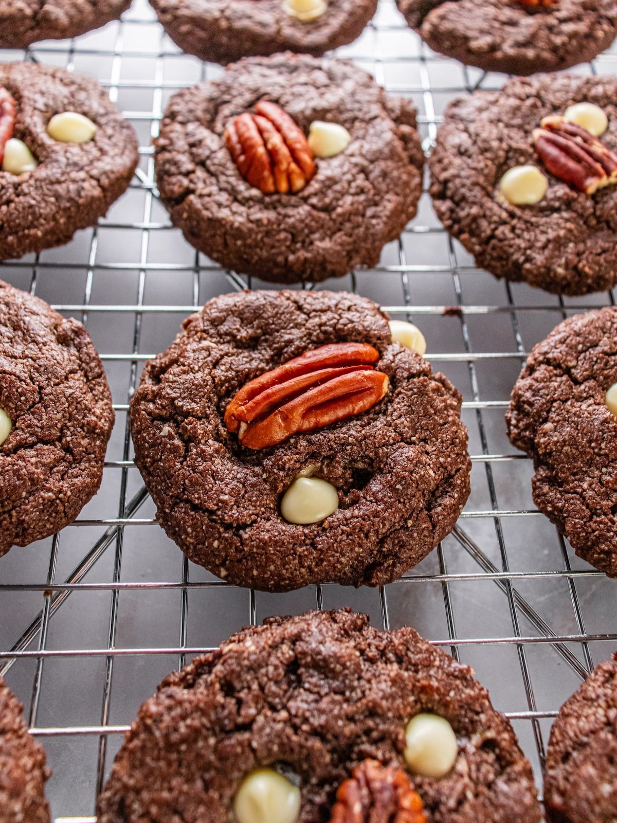 White chocolate pecan cookies on a cooling rack.