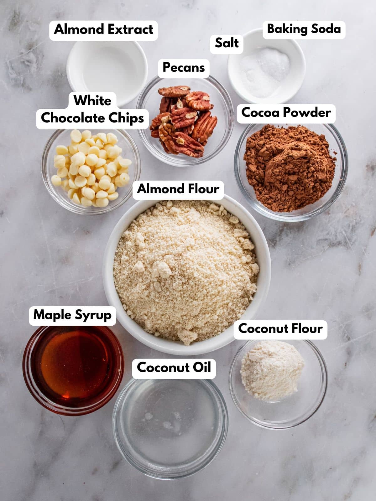 Ingredients for making white chocolate pecan cookies in bowls.