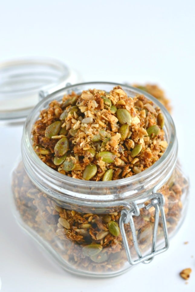 A super simple Paleo Granola made of almonds, seeds, shredded coconut and lathered in coconut oil and honey. A nutty and seedy snack that's irresistible and seriously addicting!