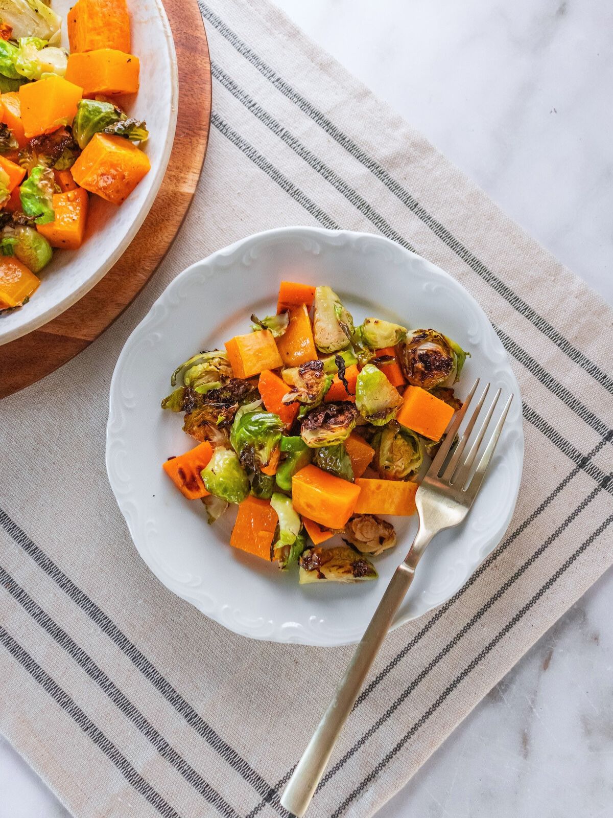 A plate of warm Brussels sprouts salad on a table.