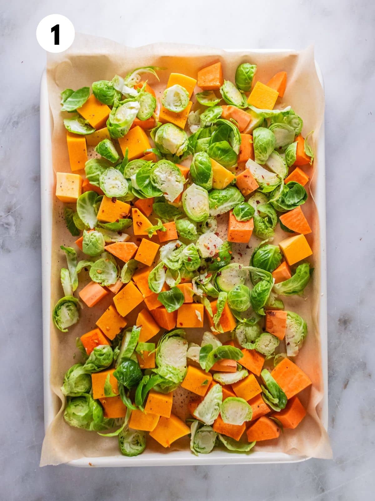 Vegetables spread out on a baking sheet.