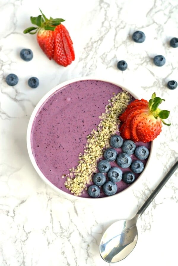 Wake up to a creamy Berry Hemp Smoothie Bowl laced with sweet berries, Greek yogurt and hemp protein powder! This gluten free smoothie bowl is a nutritious and refreshing meal or snack for warm weather and great for post workout recovery!