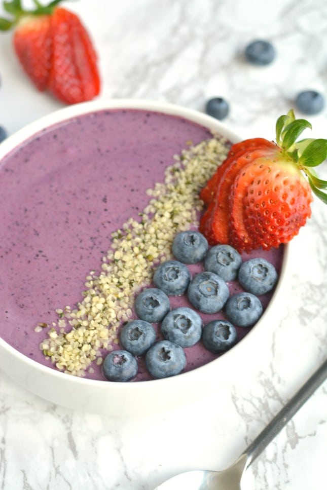 Wake up to a creamy Berry Hemp Smoothie Bowl laced with sweet berries, Greek yogurt and hemp protein powder! This gluten free smoothie bowl is a nutritious and refreshing meal or snack for warm weather and great for post workout recovery! 