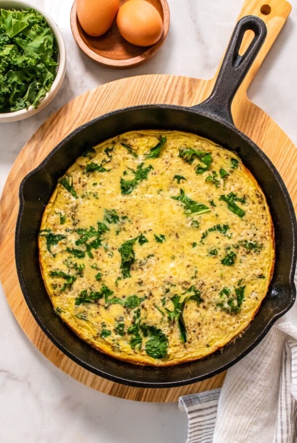 Cauliflower Kale Frittata is a low calorie egg bake with cauliflower rice, kale and spices! A savory protein breakfast that only has four ingredients and takes under 30 minutes to make!