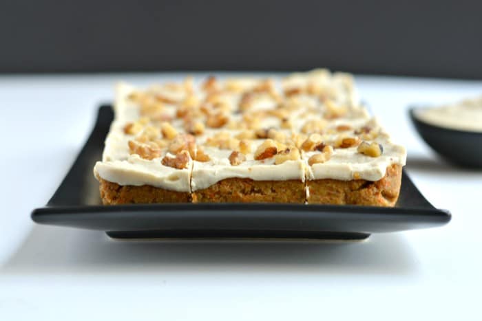 Paleo Raw Carrot Cake is a spin on a traditional favorite! Made with a carrot, date and walnut base, this delicious cake is topped with a silky cashew maple coconut icing that's surprisingly healthy and good for you. This is what carrot cake dreams are made of! 
