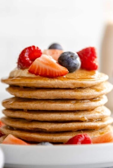 A stack of cottage cheese protein pancakes on the table with berries.
