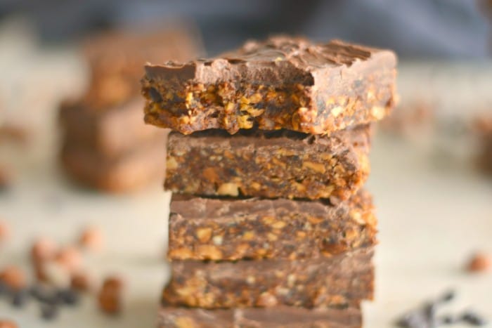 Peanut Butter Chocolate Chip Bars that taste like candy and are good for you! Made with four ingredients and sweetened with dates, these simple no bake bars are vegan, gluten free and Paleo. A healthy snack bar everyone loves!