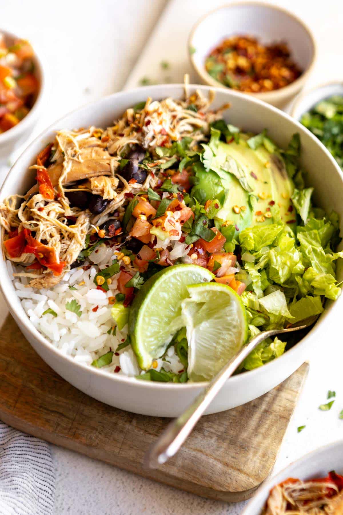 Make taco night easy night with these Crockpot Chicken Taco Bowls! Made naturally gluten free with homemade low sodium taco seasoning and layered with fresh vegetables, this low calorie dinner is one everyone will love especially the cook! 