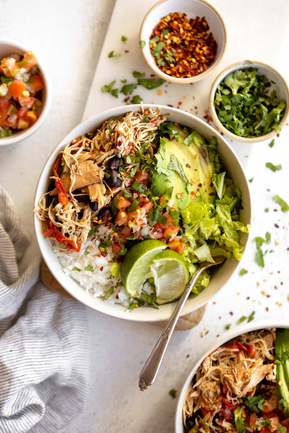 Make taco night easy night with these Crockpot Chicken Taco Bowls! Made naturally gluten free with homemade low sodium taco seasoning and layered with fresh vegetables, this low calorie dinner is one everyone will love especially the cook! 
