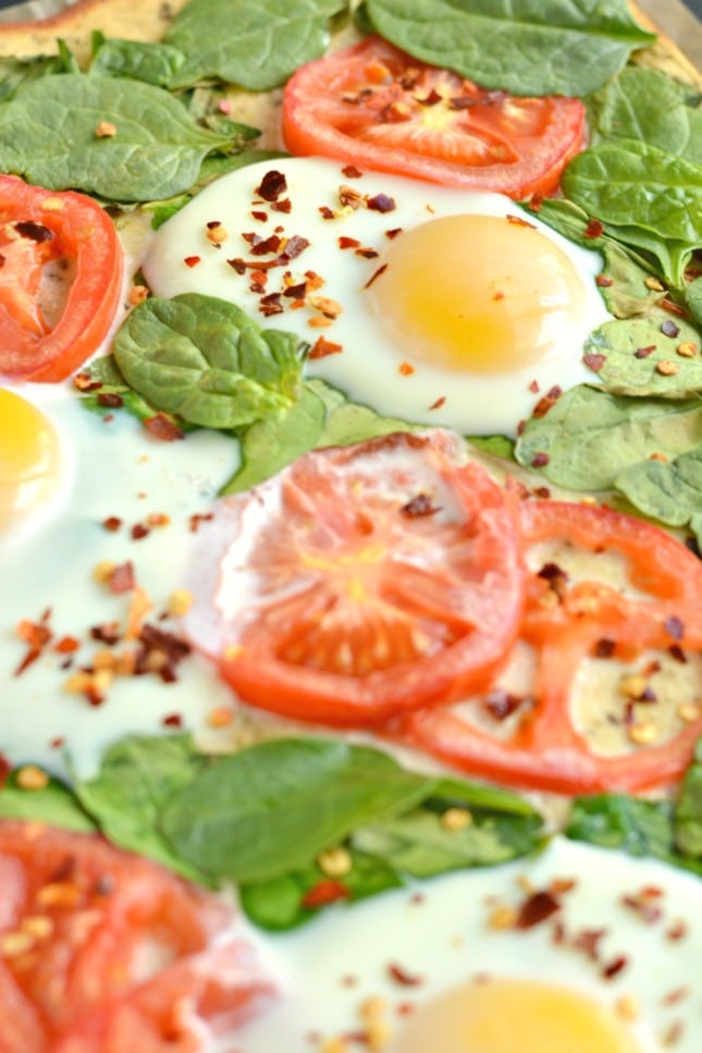 Wake up to Paleo Breakfast Pizza! Made with a simple coconut egg crust and topped with fresh veggies and cracked eggs, this is a perfect, easy meal for any time of day!
