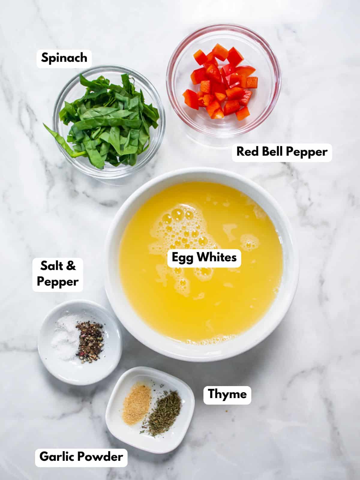 Egg white muffins ingredients in bowls on a counter.