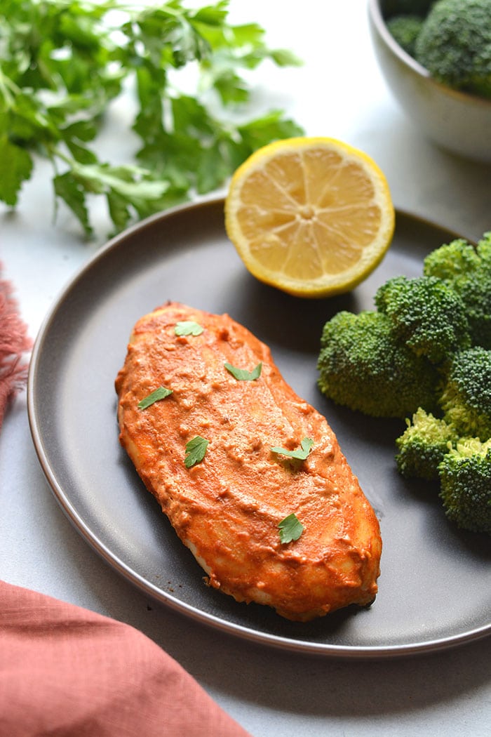 Greek Yogurt Paprika Chicken marinaded with yogurt, lemon and paprika! This gluten free, low calorie chicken recipe has a spicy kick and is high protein! Gluten Free + Low Calorie