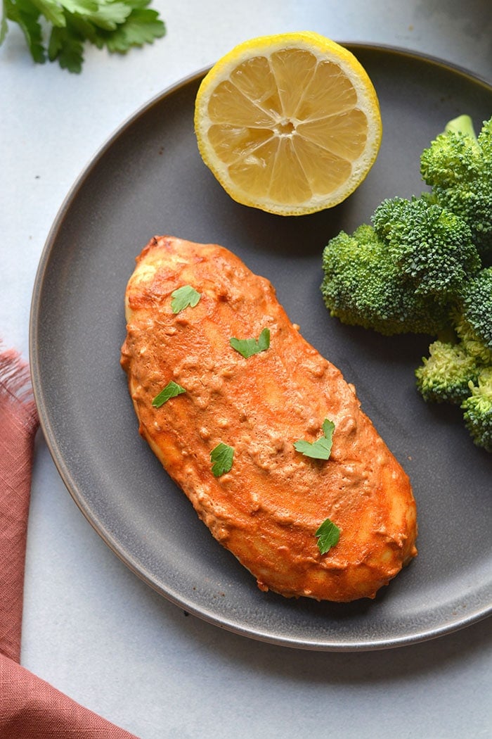 Greek Yogurt Paprika Chicken marinaded with yogurt, lemon and paprika! This gluten free, low calorie chicken recipe has a spicy kick and is high protein! Gluten Free + Low Calorie