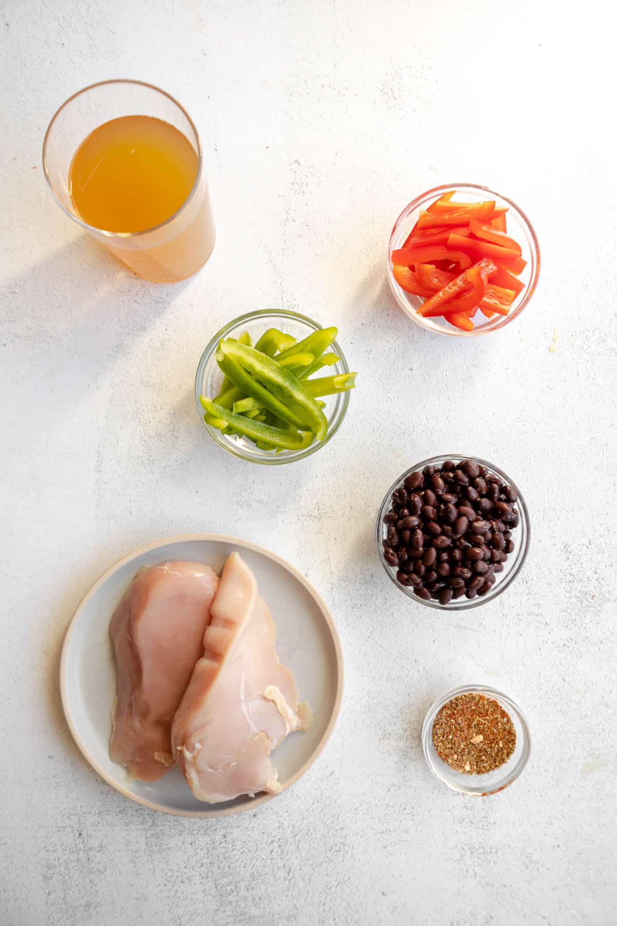 Ingredients to make slow cooker chicken taco bowls on the table before making.