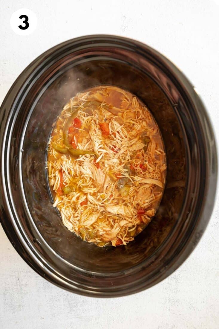 Crockpot chicken taco bowl meat in the slow cooker after cooking.