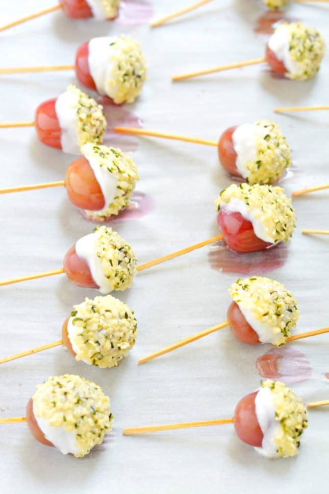 Transform frozen grapes into Greek Yogurt Grape Popsicles dipped in hemp seeds! A sweet & healthy snack, perfect for hot days and always a party favorite!