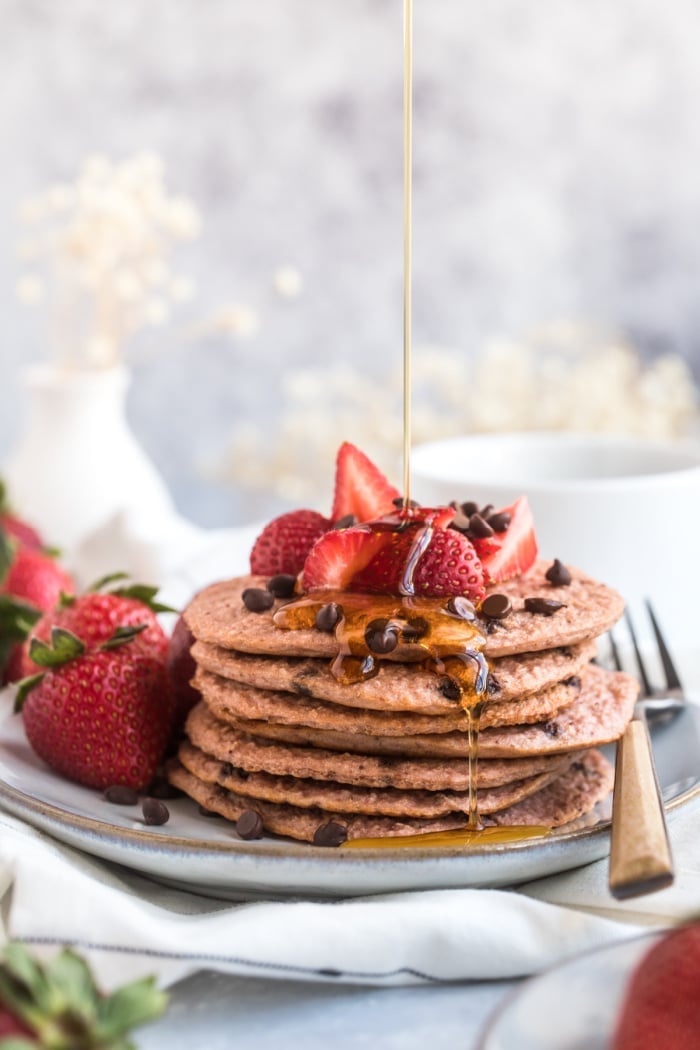 Healthy Strawberry Oat Chocolate Chip Pancakes made low calorie with gluten free oats and Greek yogurt. A healthy strawberry pancake recipe! 