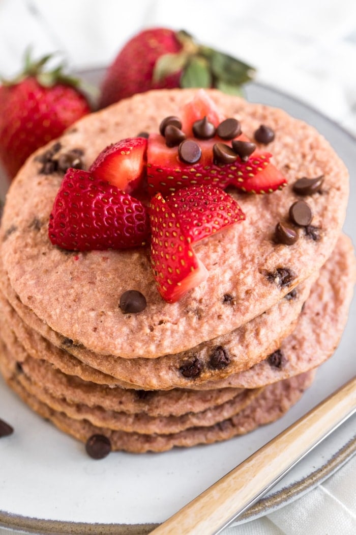 Healthy Strawberry Oat Chocolate Chip Pancakes made low calorie with gluten free oats and Greek yogurt. A healthy strawberry pancake recipe!