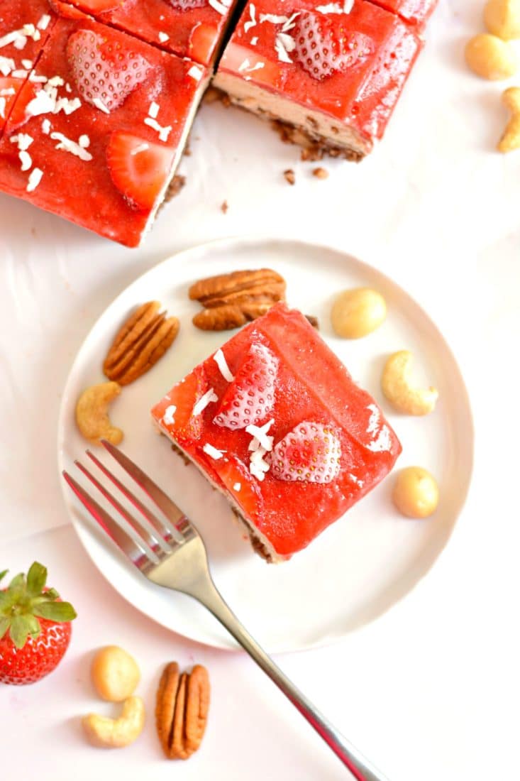 Raw Strawberry Cake is a nutrition powerhouse! Made with a cocoa macadamia pecan crust, creamy cashew filling and topped with a strawberry sauce, this is a dessert you cannot resist. Vegan, Paleo, gluten free, grain free & dairy free!