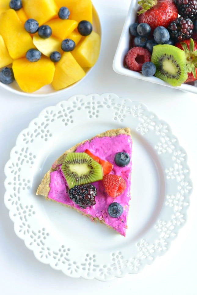 Tropical Smoothie Berry Breakfast Pizza made with a gluten free oat crust and topped with a Greek yogurt dragon fruit smoothie and fresh fruit. A delicious breakfast or dessert for summer that's made in a blender!