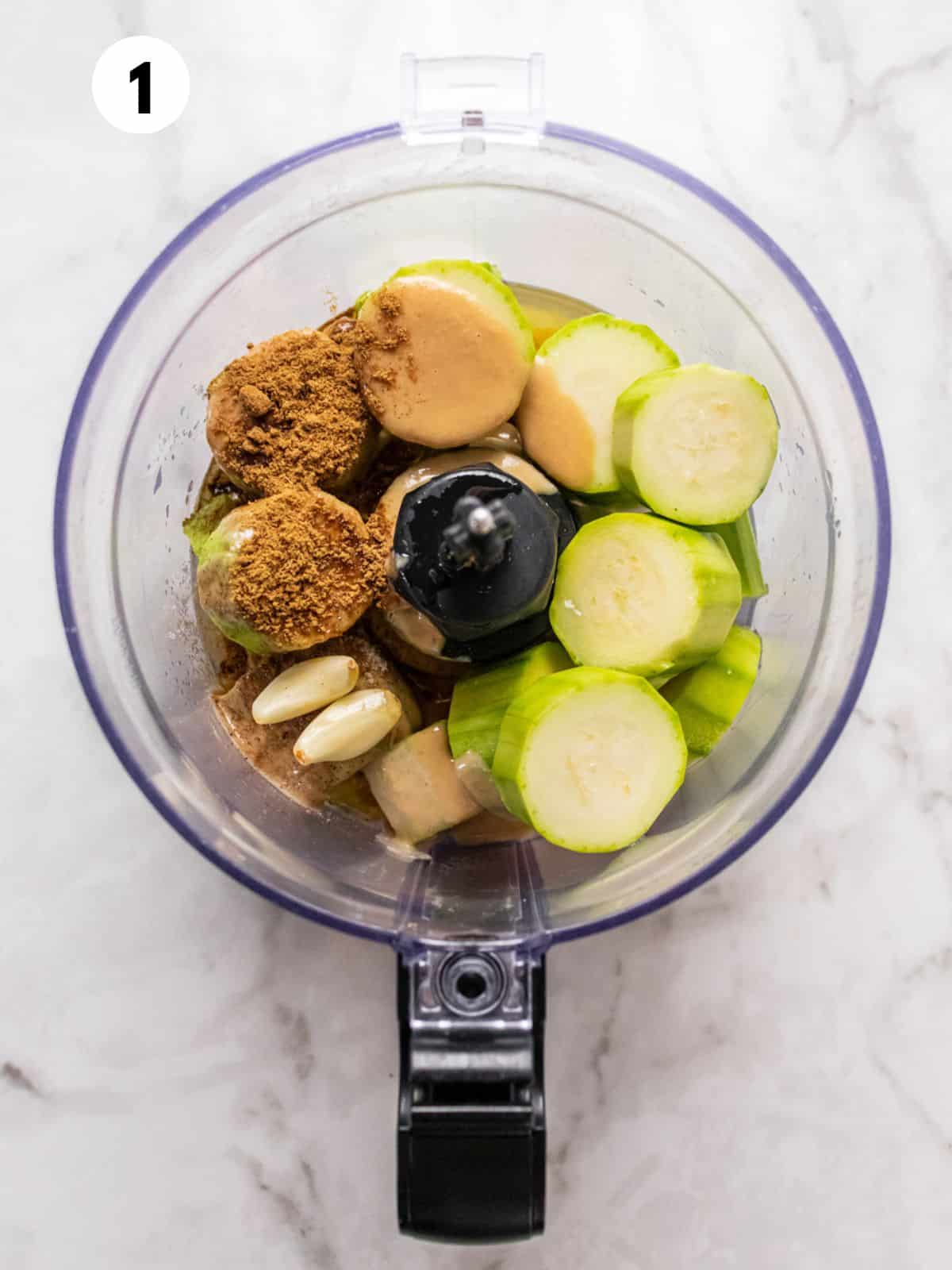 Ingredients for making zucchini hummus in a food processor.
