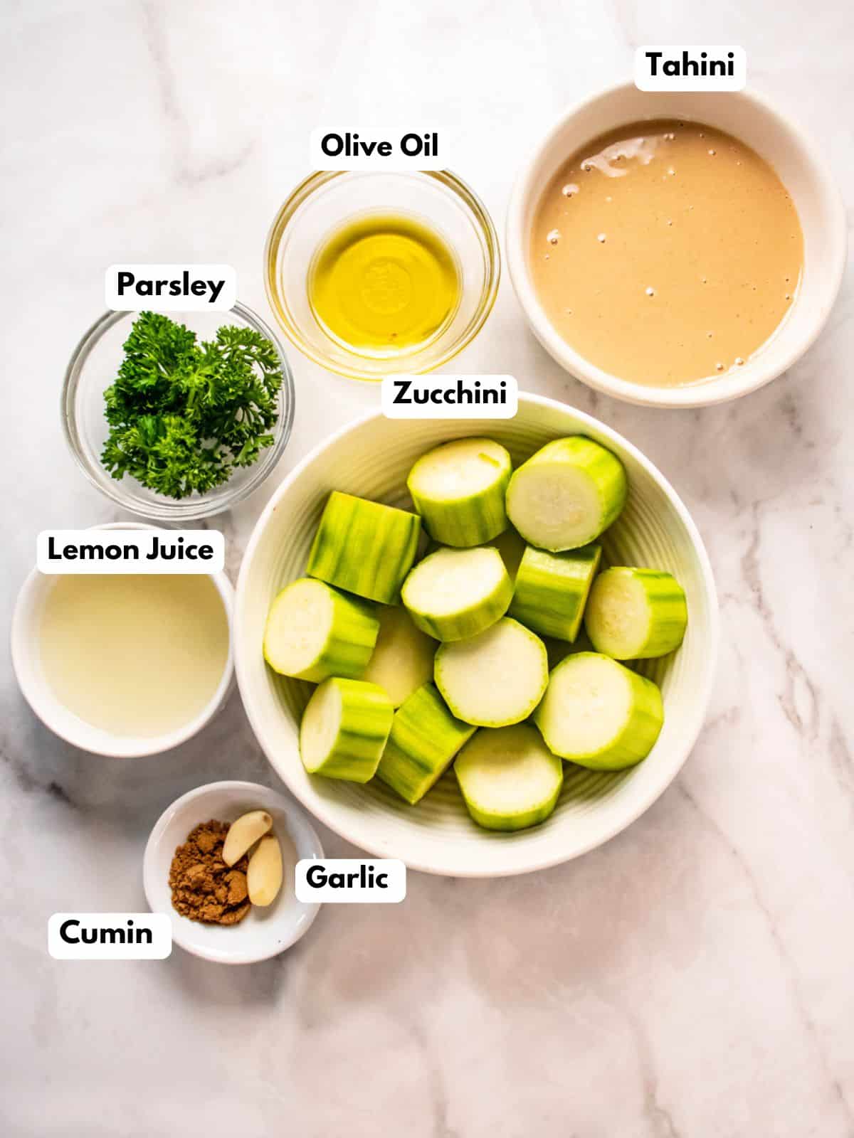 Ingredients to make zucchini hummus in bowls.