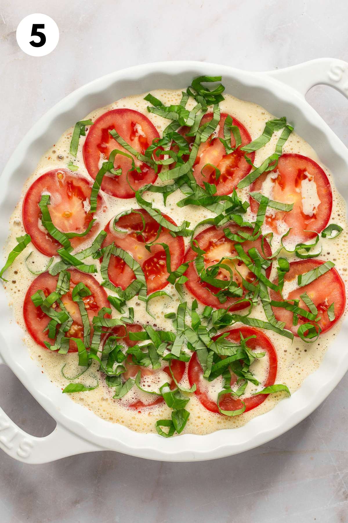 Basil sprinkled over the top of the sliced tomatoes and egg mixture.